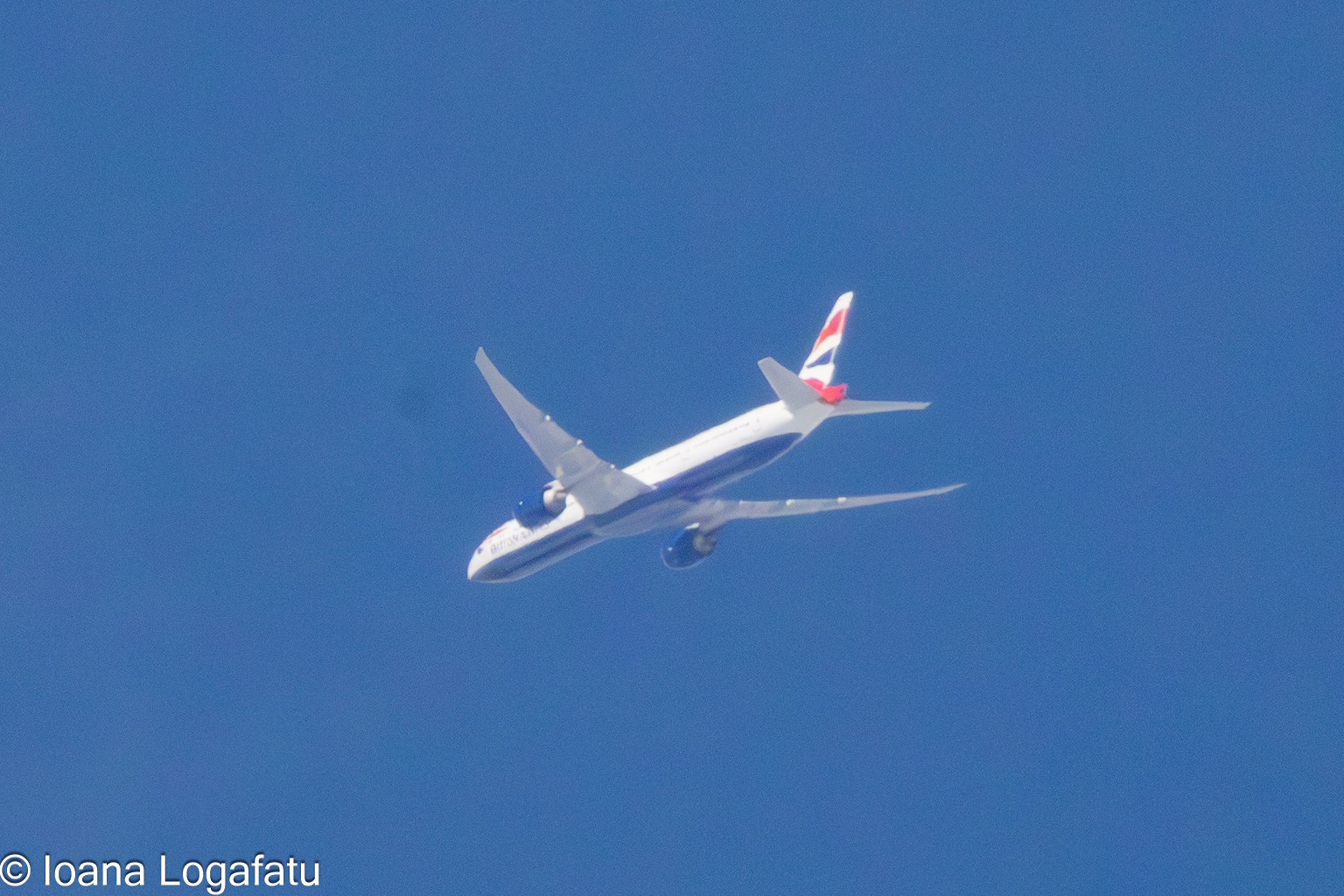 Airplane soaring high in the clear blue sky